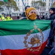 Protester scales Iranian embassy in London, replaces flag with opposition symbol