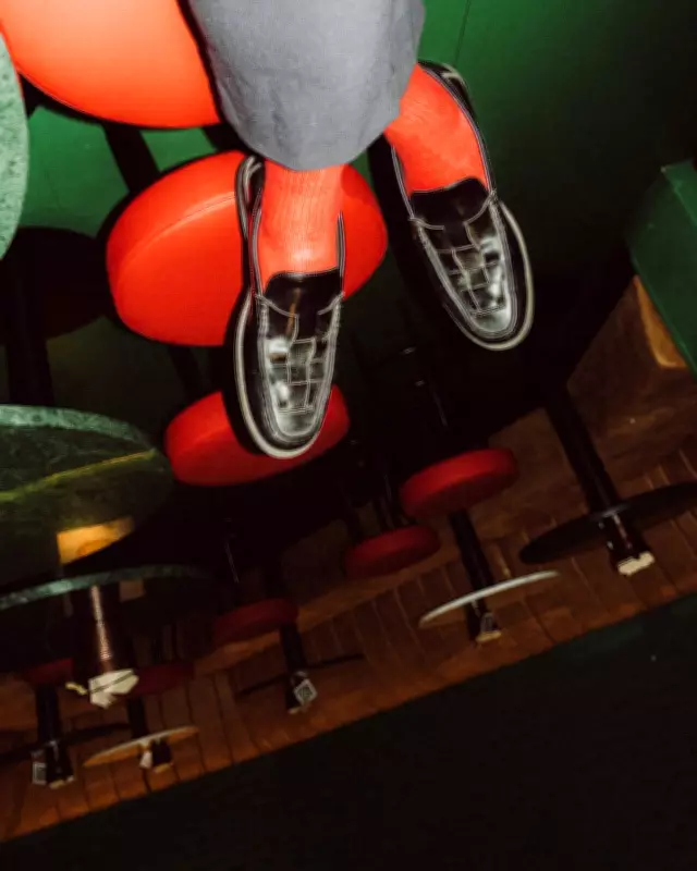 Tilted Loafers and Red Socks: Olivier Lei's Vibrant Bar Photo