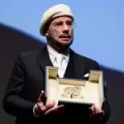 John Travolta Overcome with Emotion at Cannes as He Receives Surprise Honorary Palme d'Or
