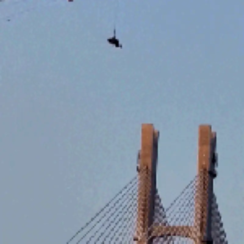 Paraglider dangling 60m after parachute caught on tower crane in China