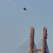 Paraglider dangling 60m after parachute caught on tower crane in China